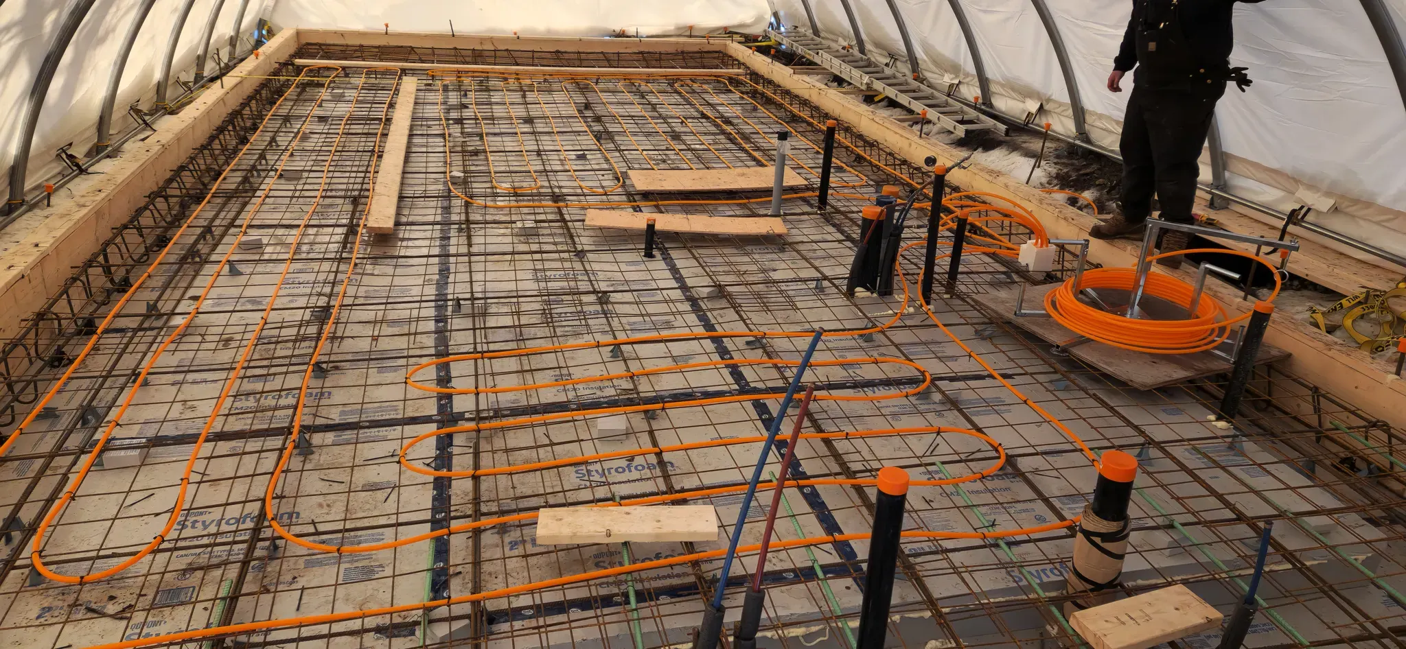 In-floor radiant heating loops laid over rebar before a slab pour
