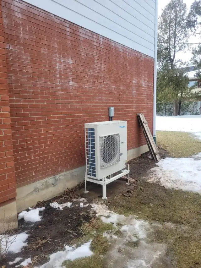 A Denoco outdoor HVAC or heat pump unit on a job site