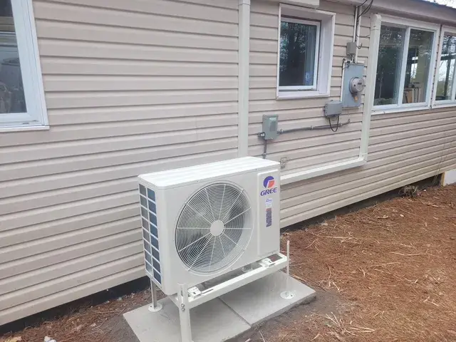 A Denoco outdoor HVAC or heat pump unit on a job site
