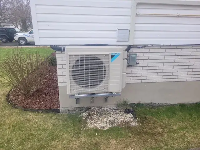 A Denoco outdoor HVAC or heat pump unit on a job site