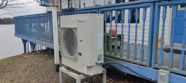 A Denoco outdoor HVAC or heat pump unit on a job site