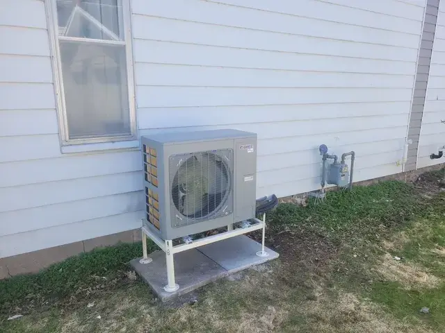 A Denoco outdoor HVAC or heat pump unit on a job site