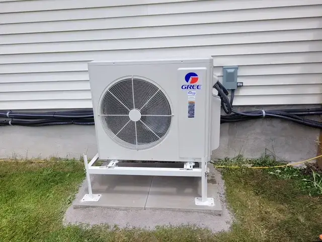 A Denoco outdoor HVAC or heat pump unit on a job site