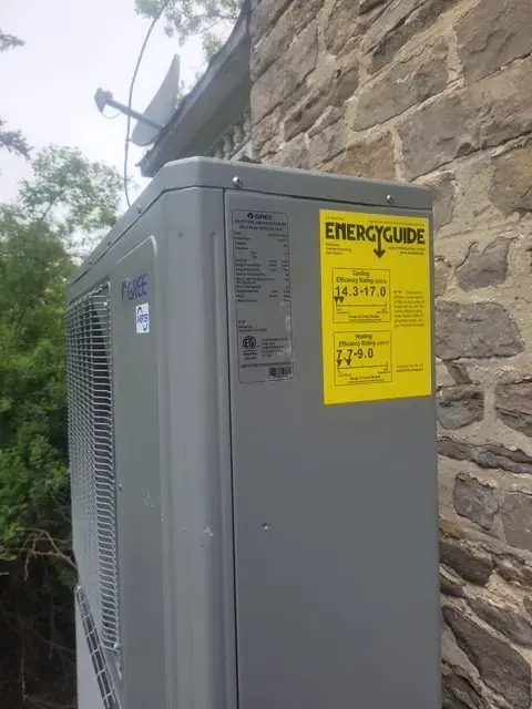 A Denoco outdoor HVAC or heat pump unit on a job site