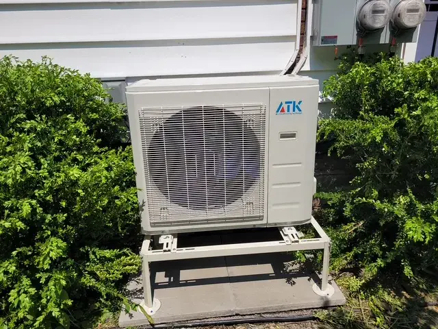 A Denoco outdoor HVAC or heat pump unit on a job site