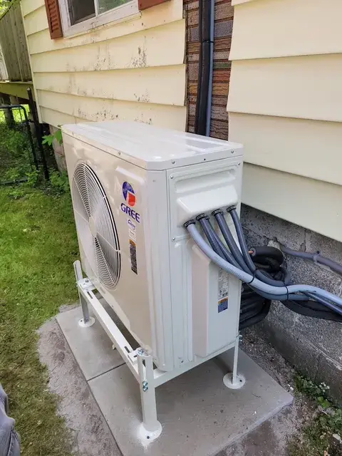 A Denoco outdoor HVAC or heat pump unit on a job site