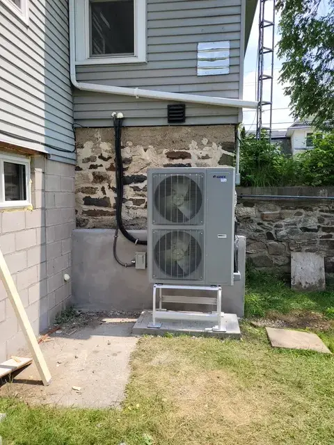 A Denoco outdoor HVAC or heat pump unit on a job site
