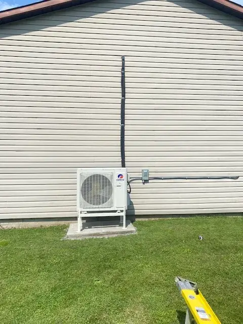 A Denoco outdoor HVAC or heat pump unit on a job site
