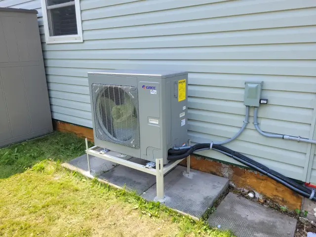 A Denoco outdoor HVAC or heat pump unit on a job site