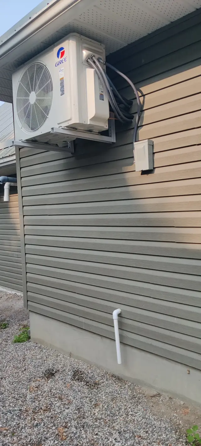 A Denoco outdoor HVAC or heat pump unit on a job site