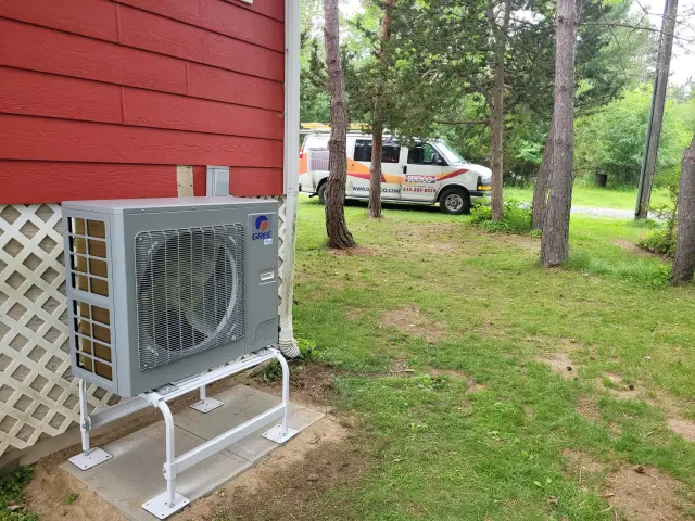 A Denoco outdoor HVAC or heat pump unit on a job site