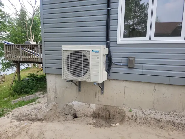 A Denoco outdoor HVAC or heat pump unit on a job site