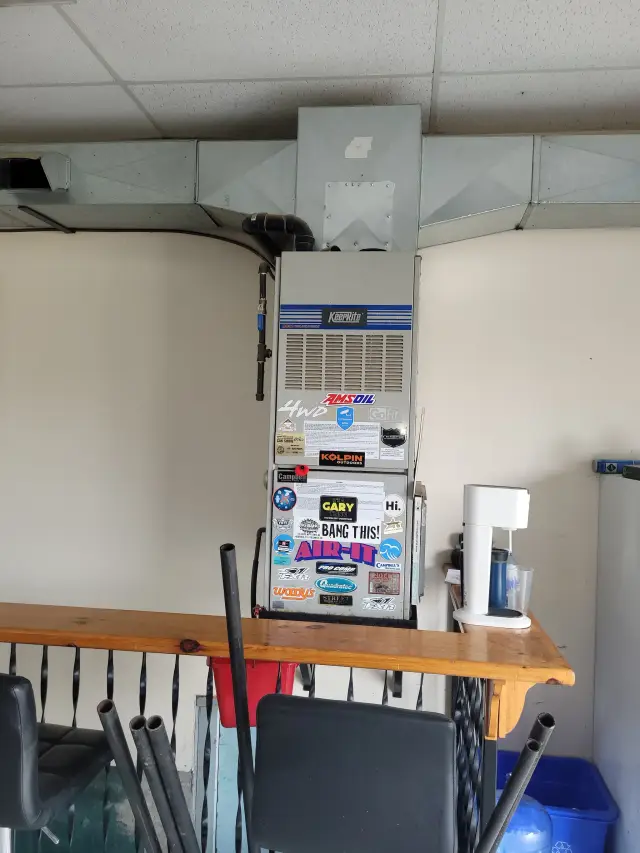 A Denoco outdoor HVAC or heat pump unit on a job site