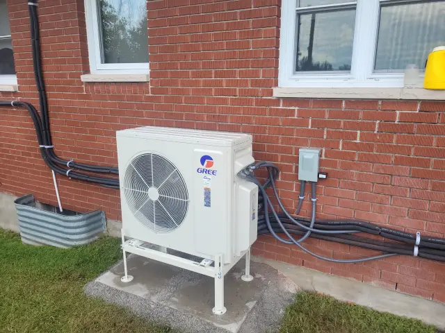 A Denoco outdoor HVAC or heat pump unit on a job site