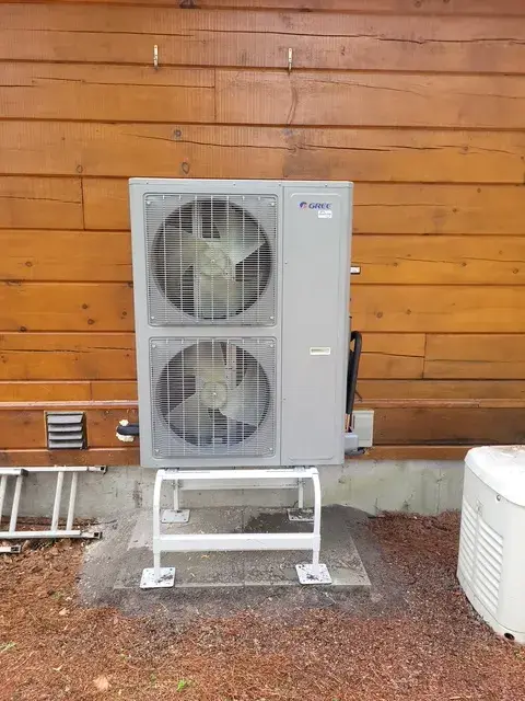 A Denoco outdoor HVAC or heat pump unit on a job site