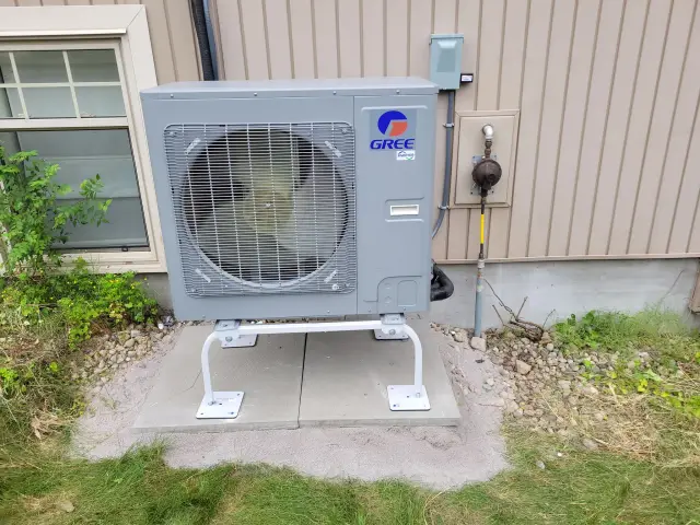 A Denoco outdoor HVAC or heat pump unit on a job site