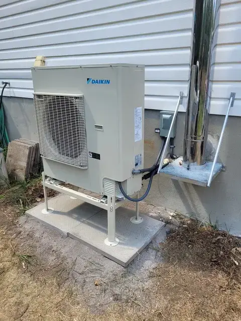 A Denoco outdoor HVAC or heat pump unit on a job site