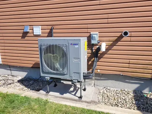 A Denoco outdoor HVAC or heat pump unit on a job site