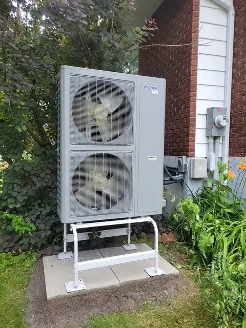 A Denoco outdoor HVAC or heat pump unit on a job site