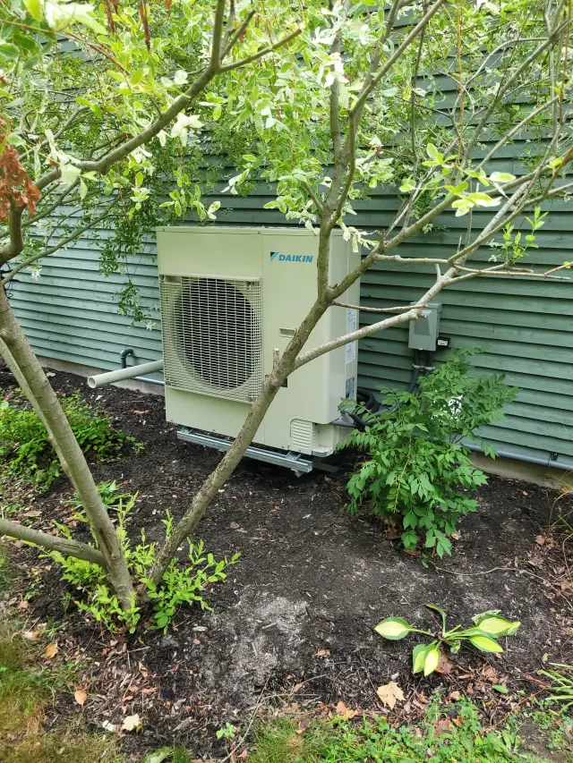 A Denoco outdoor HVAC or heat pump unit on a job site