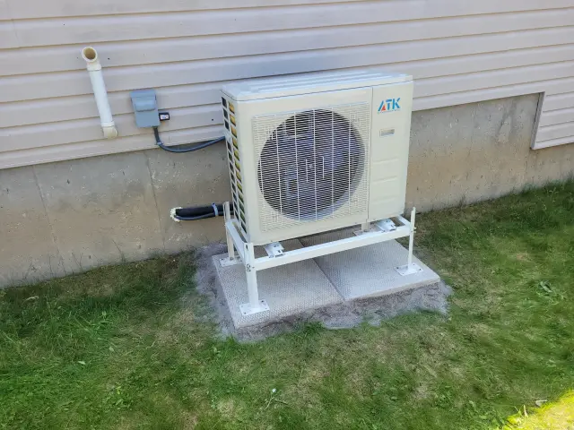 A Denoco outdoor HVAC or heat pump unit on a job site