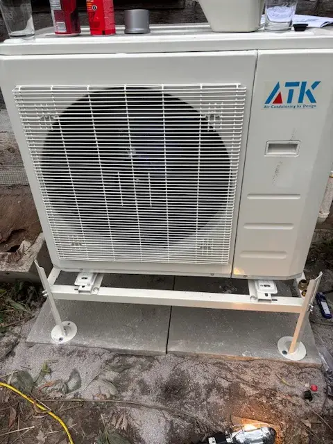 A Denoco outdoor HVAC or heat pump unit on a job site
