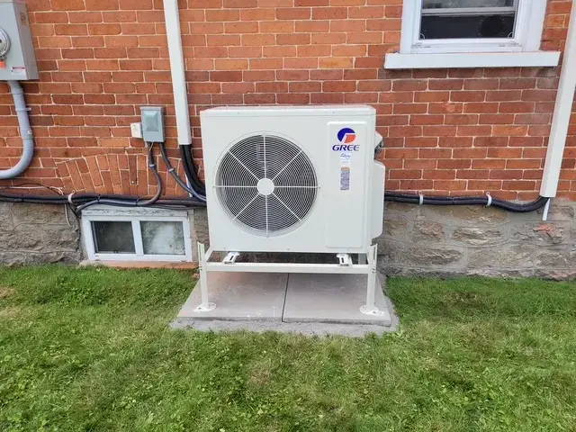A Denoco outdoor HVAC or heat pump unit on a job site