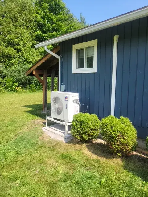 A Denoco outdoor HVAC or heat pump unit on a job site