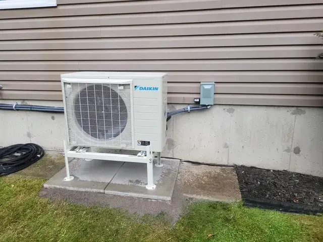 A Denoco outdoor HVAC or heat pump unit on a job site
