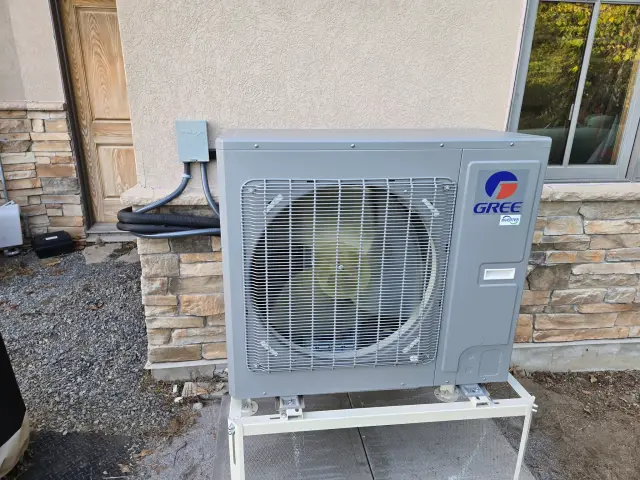 A Denoco outdoor HVAC or heat pump unit on a job site