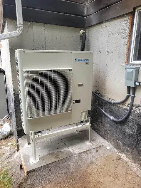 A Denoco outdoor HVAC or heat pump unit on a job site