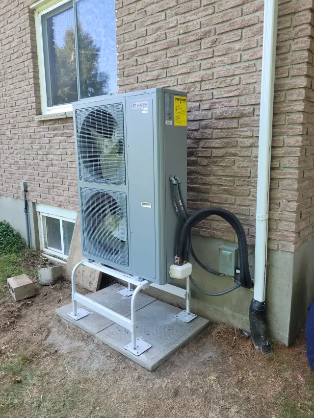 A Denoco outdoor HVAC or heat pump unit on a job site