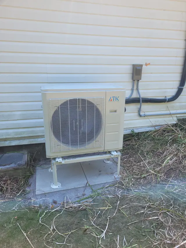 A Denoco outdoor HVAC or heat pump unit on a job site