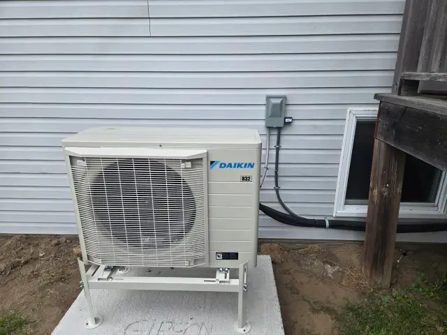 A Denoco outdoor HVAC or heat pump unit on a job site