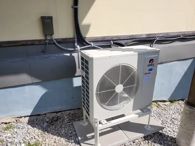 A Denoco outdoor HVAC or heat pump unit on a job site
