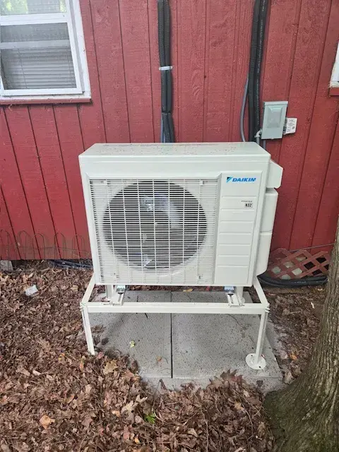 A Denoco outdoor HVAC or heat pump unit on a job site