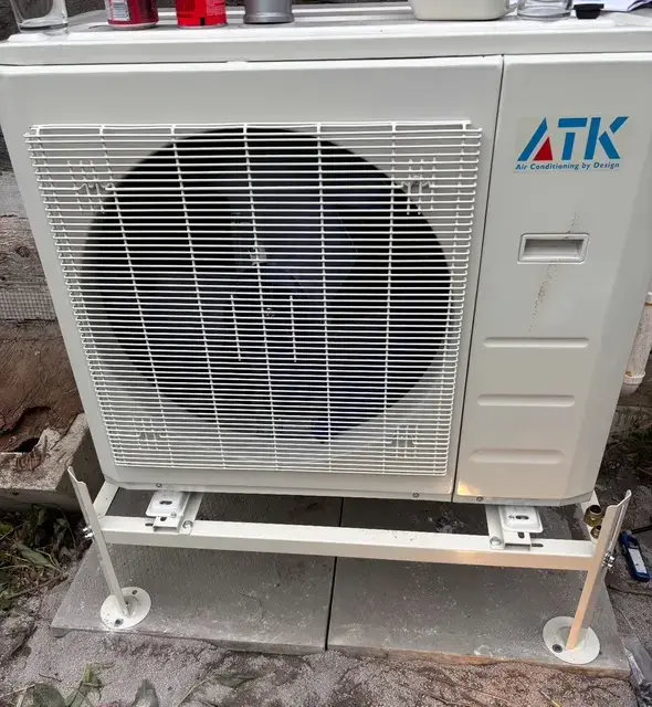A Denoco outdoor HVAC or heat pump unit on a job site