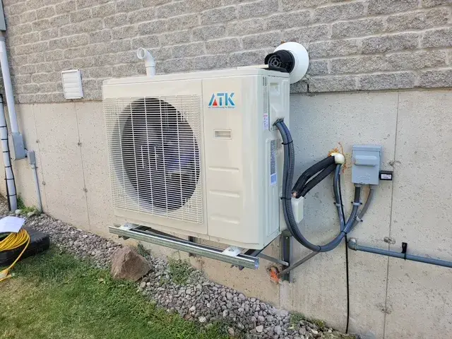 A Denoco outdoor HVAC or heat pump unit on a job site