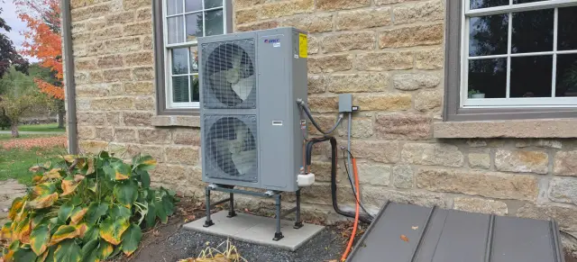 A Denoco outdoor HVAC or heat pump unit on a job site