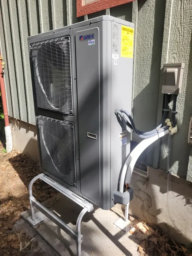 A Denoco outdoor HVAC or heat pump unit on a job site