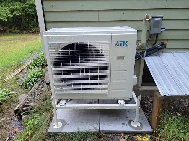 A Denoco outdoor HVAC or heat pump unit on a job site