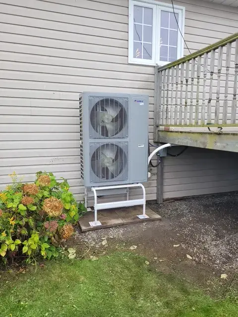 A Denoco outdoor HVAC or heat pump unit on a job site
