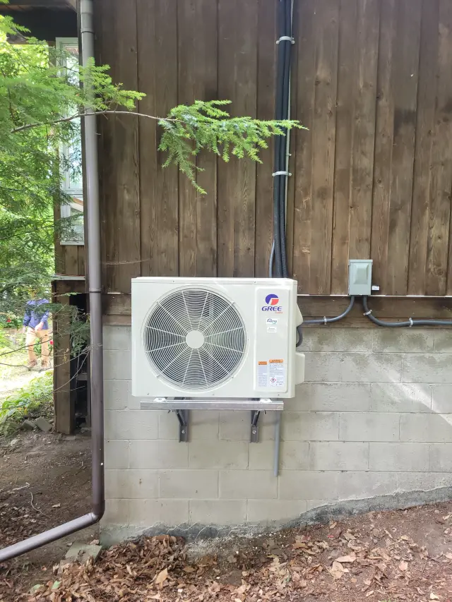 A Denoco outdoor HVAC or heat pump unit on a job site