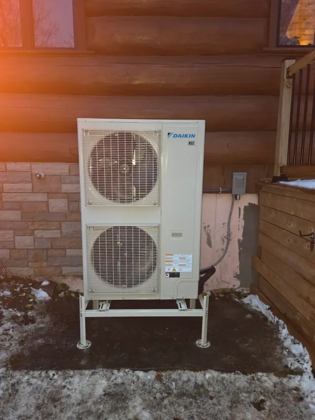 A Denoco outdoor HVAC or heat pump unit on a job site