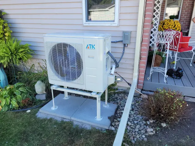 A Denoco outdoor HVAC or heat pump unit on a job site