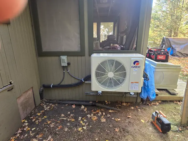 A Denoco outdoor HVAC or heat pump unit on a job site
