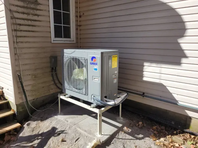 A Denoco outdoor HVAC or heat pump unit on a job site