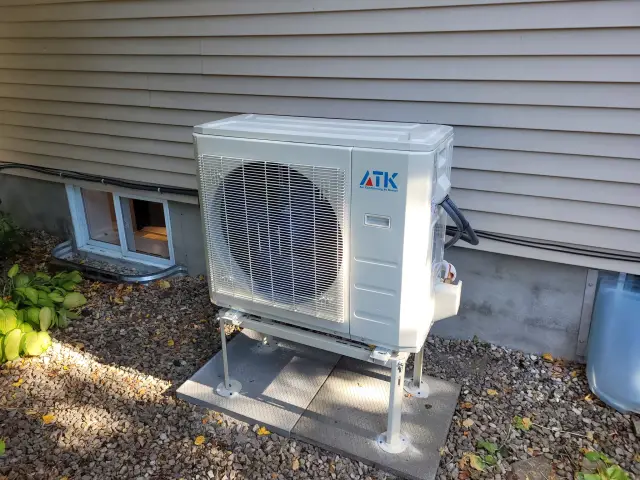 A Denoco outdoor HVAC or heat pump unit on a job site