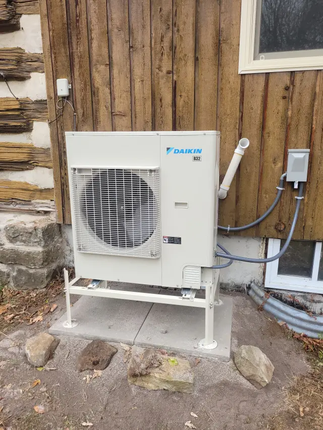 A Denoco outdoor HVAC or heat pump unit on a job site