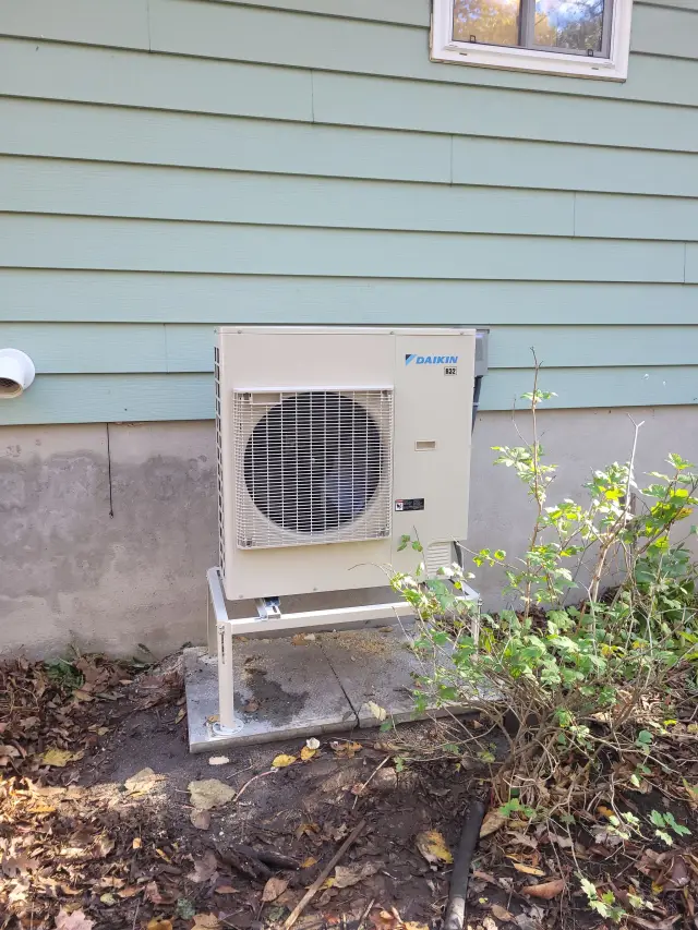 A Denoco outdoor HVAC or heat pump unit on a job site